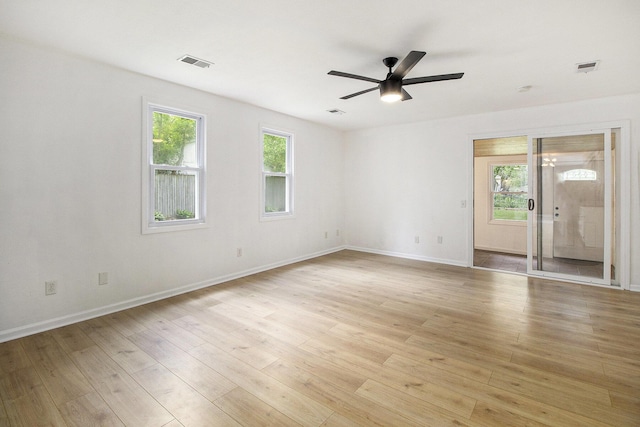 empty room with ceiling fan, baseboards, and light wood-style floors