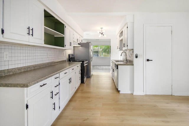 kitchen featuring stainless steel range with electric stovetop, a sink, open shelves, and backsplash