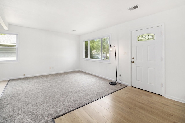 entrance foyer with light wood-style flooring and baseboards