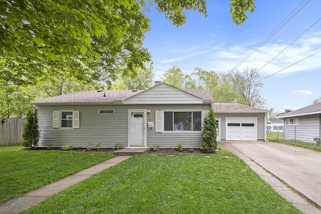 view of front of home featuring driveway, an attached garage, and roof with shingles