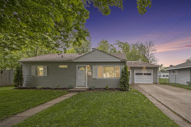 view of front of home featuring driveway, an attached garage, and a shingled roof