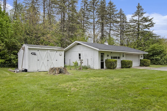 garage featuring driveway and a storage unit