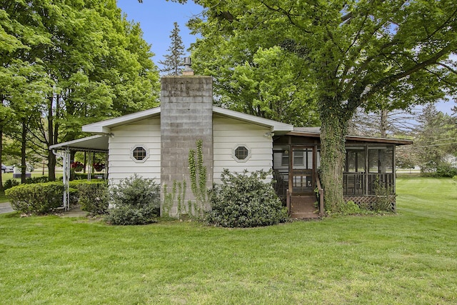 view of outdoor structure featuring a sunroom and an attached carport