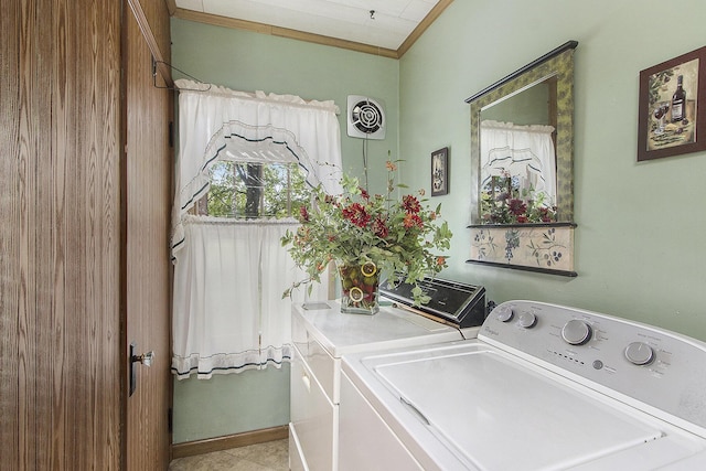 clothes washing area featuring washing machine and dryer and ornamental molding
