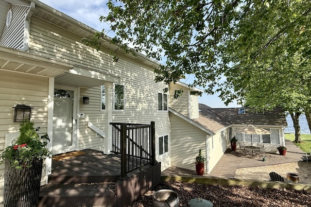 doorway to property with a deck and a patio area