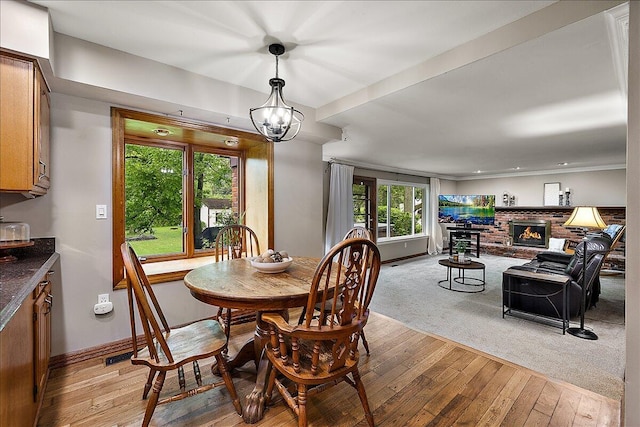 50951 Murray Hill Dr, Canton, MI 48187 - dining space with light wood-style floors, baseboards, and a brick fireplace