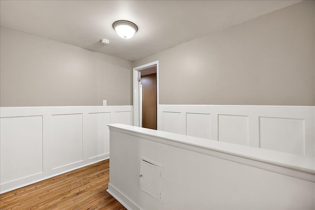 50951 Murray Hill Dr, Canton, MI 48187 - hall featuring a wainscoted wall, wood finished floors, and a decorative wall