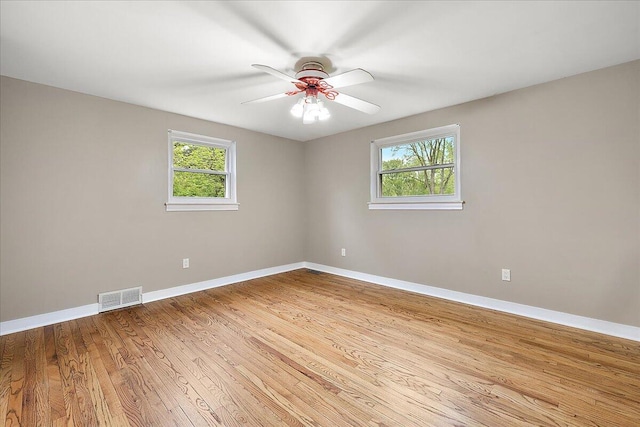 50951 Murray Hill Dr, Canton, MI 48187 - spare room featuring plenty of natural light, wood finished floors, baseboards, and ceiling fan