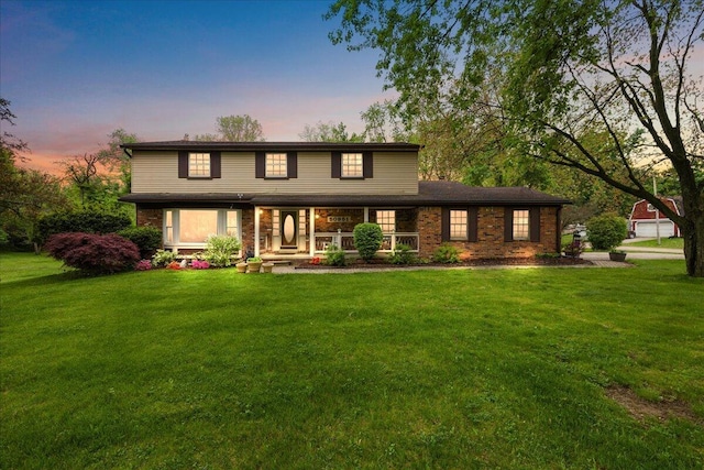 50951 Murray Hill Dr, Canton, MI 48187 - view of front facade with a porch, a front lawn, and brick siding