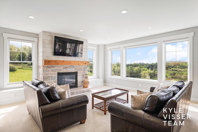 11650 Lally St NE, Lowell, MI 49331 - living room with light carpet, recessed lighting, a fireplace, and baseboards