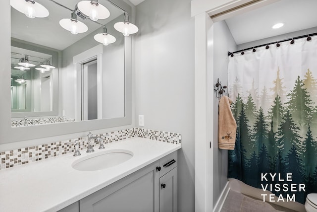 11650 Lally St NE, Lowell, MI 49331 - bathroom with backsplash, vanity, and baseboards