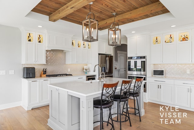11650 Lally St NE, Lowell, MI 49331 - kitchen featuring appliances with stainless steel finishes, wooden ceiling, recessed lighting, an island with sink, and a sink