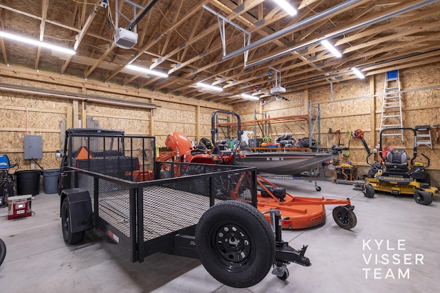 11650 Lally St NE, Lowell, MI 49331 - garage featuring a garage door opener and a workshop area