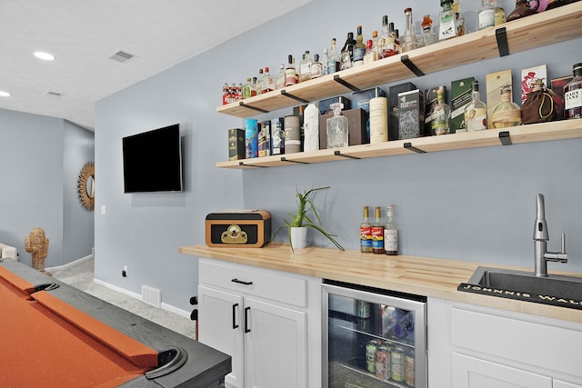 12700 Mcpherson St NE, Lowell, MI 49331 - indoor dry bar with wine cooler, light colored carpet, recessed lighting, and baseboards