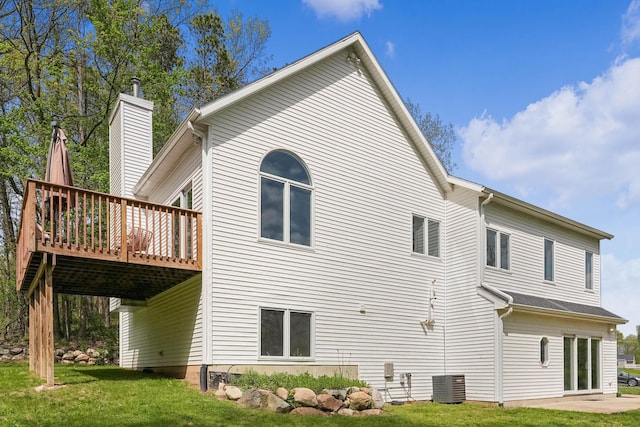 12700 Mcpherson St NE, Lowell, MI 49331 - rear view of house featuring central AC, a deck, and a yard