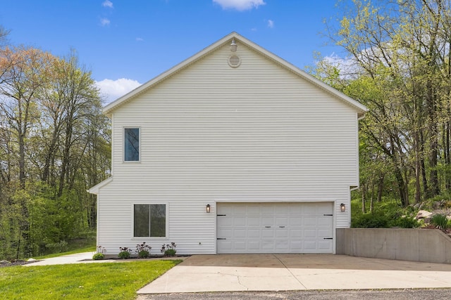 12700 Mcpherson St NE, Lowell, MI 49331 - view of side of property featuring a garage, a yard, and driveway