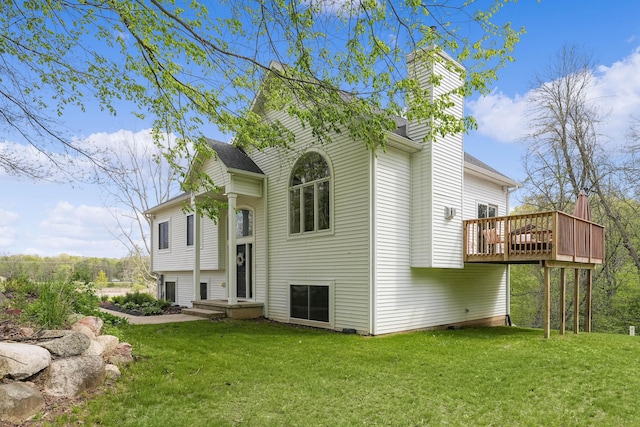 12700 Mcpherson St NE, Lowell, MI 49331 - view of front of home with a chimney, a front yard, and a wooden deck