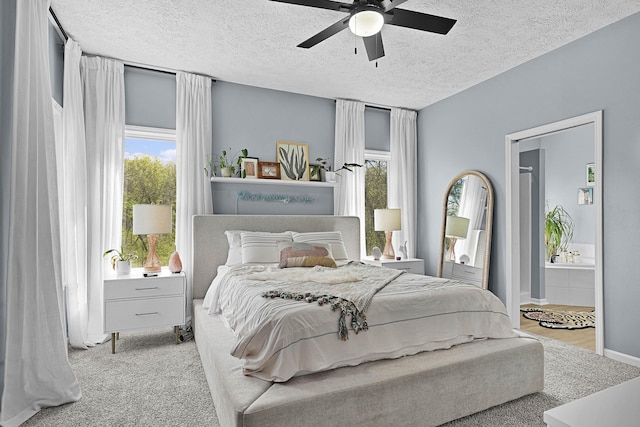 12700 Mcpherson St NE, Lowell, MI 49331 - bedroom featuring a textured ceiling, ceiling fan, ensuite bath, and carpet floors