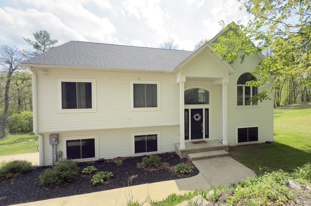 12700 Mcpherson St NE, Lowell, MI 49331 - raised ranch featuring a front yard and a shingled roof