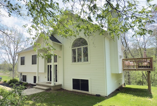 12700 Mcpherson St NE, Lowell, MI 49331 - view of front facade with a front lawn and a wooden deck