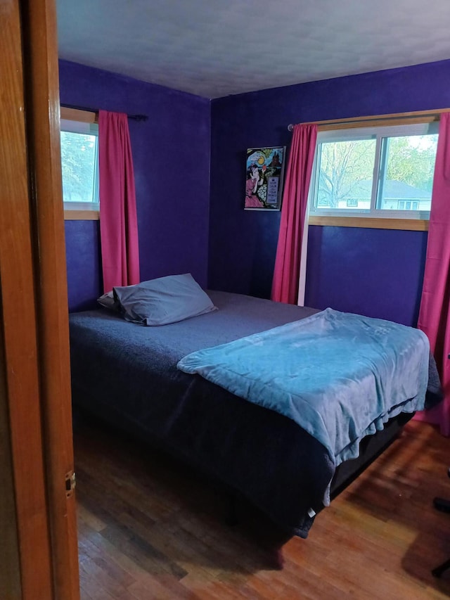 317 Country Club Ter, Battle Creek, MI 49015 - bedroom with multiple windows and wood finished floors