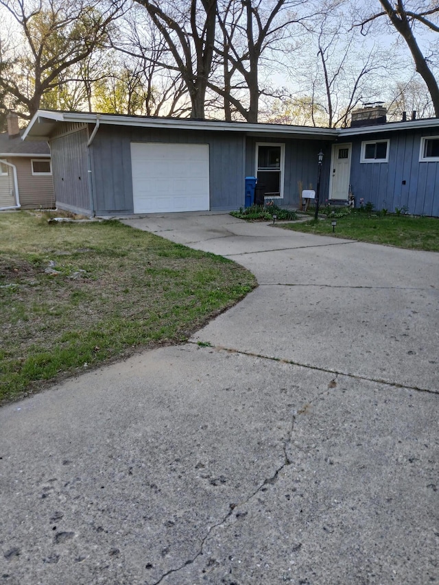 317 Country Club Ter, Battle Creek, MI 49015 - ranch-style home featuring an attached garage, concrete driveway, and board and batten siding