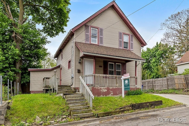 412 Breens Ct SW, Grand Rapids, MI 49503 - view of front facade with a porch, fence, and a shingled roof