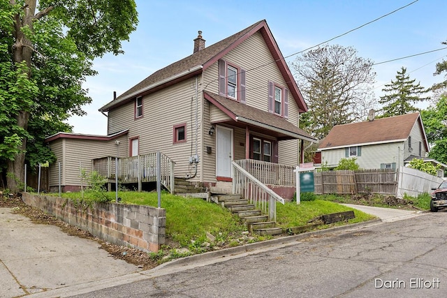 412 Breens Ct SW, Grand Rapids, MI 49503 - view of front of property with a chimney, a porch, fence, and a shingled roof