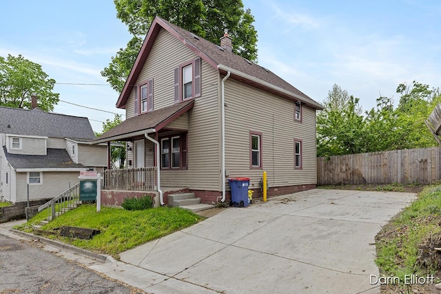 412 Breens Ct SW, Grand Rapids, MI 49503 - view of front of home featuring a porch, fence, a chimney, and a shingled roof