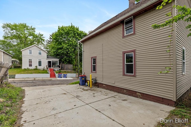 412 Breens Ct SW, Grand Rapids, MI 49503 - rear view of property with a patio and a chimney