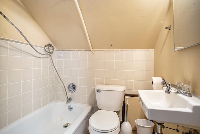 bathroom featuring a sink, toilet, and vaulted ceiling