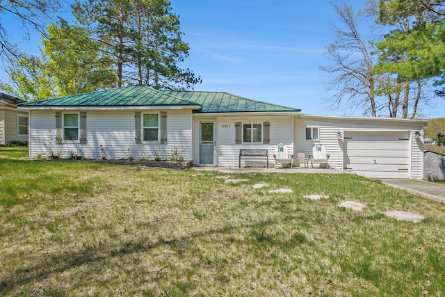 3957 Cleveland Dr W, Bitely, MI 49309 - ranch-style house featuring a standing seam roof, an attached garage, a front lawn, metal roof, and driveway
