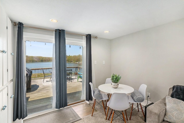 3957 Cleveland Dr W, Bitely, MI 49309 - dining area featuring light wood-style floors, a water view, and recessed lighting
