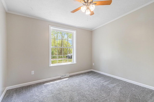 spare room featuring a textured ceiling, carpet floors, ceiling fan, ornamental molding, and baseboards