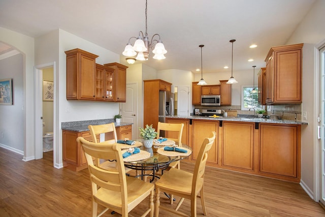 14275 Sunset Ridge Ct, Niles, MI 49120 - dining area with light wood finished floors, baseboards, arched walkways, and recessed lighting