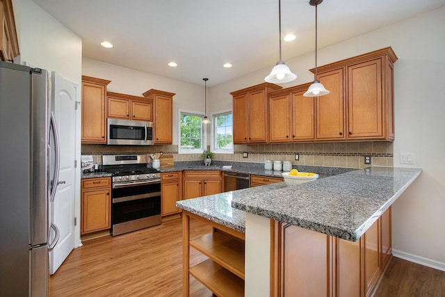 14275 Sunset Ridge Ct, Niles, MI 49120 - kitchen featuring appliances with stainless steel finishes, a peninsula, brown cabinets, decorative backsplash, and recessed lighting