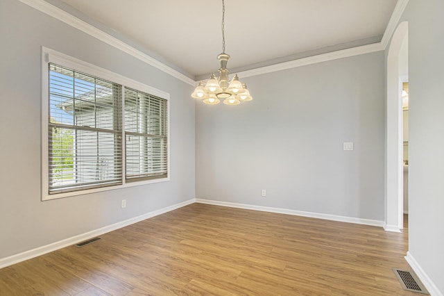 14275 Sunset Ridge Ct, Niles, MI 49120 - spare room featuring arched walkways, crown molding, healthy amount of natural light, a chandelier, and light wood-type flooring