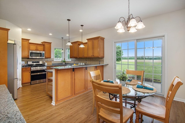 14275 Sunset Ridge Ct, Niles, MI 49120 - kitchen with appliances with stainless steel finishes, light wood finished floors, tasteful backsplash, a chandelier, and recessed lighting