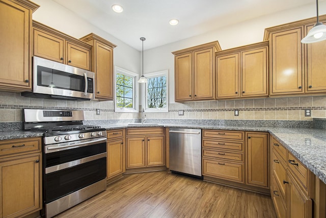 14275 Sunset Ridge Ct, Niles, MI 49120 - kitchen with stainless steel appliances, brown cabinets, a sink, and recessed lighting