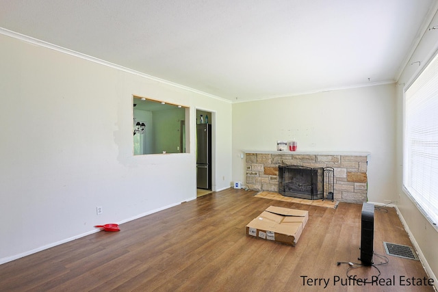 3904 Canterbury Ave, Kalamazoo, MI 49006 - living area with a stone fireplace, plenty of natural light, wood finished floors, and ornamental molding