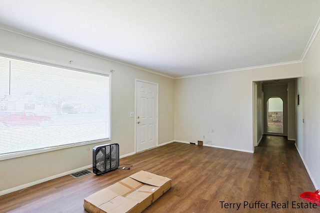 3904 Canterbury Ave, Kalamazoo, MI 49006 - unfurnished living room featuring wood finished floors, ornamental molding, arched walkways, and baseboards