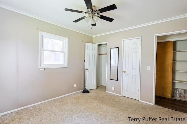 3904 Canterbury Ave, Kalamazoo, MI 49006 - unfurnished bedroom featuring carpet floors, ornamental molding, multiple closets, baseboards, and a ceiling fan
