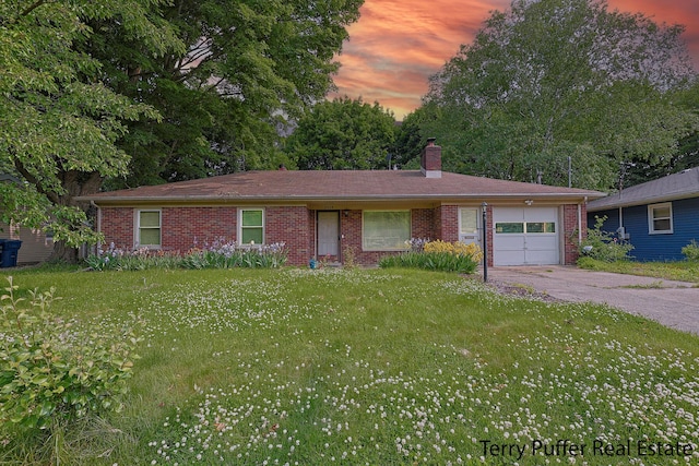 3904 Canterbury Ave, Kalamazoo, MI 49006 - ranch-style house with an attached garage, a chimney, driveway, brick siding, and a front yard