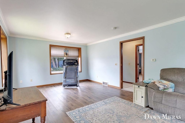 7795 Douglas Ave, Kalamazoo, MI 49009 - living area with wood finished floors, crown molding, and baseboards