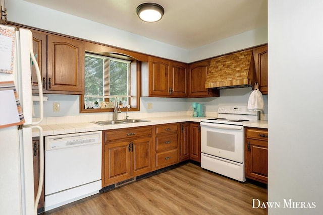 7795 Douglas Ave, Kalamazoo, MI 49009 - kitchen featuring white appliances, a sink, and brown cabinetry