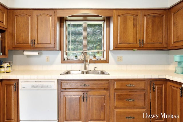 7795 Douglas Ave, Kalamazoo, MI 49009 - kitchen with dishwasher, a sink, brown cabinets, and light countertops