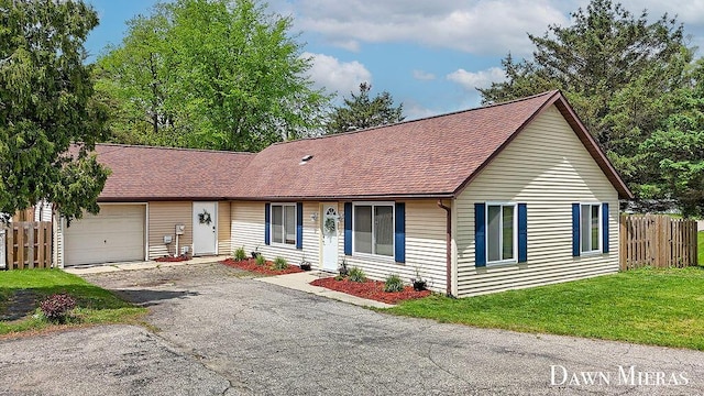 7795 Douglas Ave, Kalamazoo, MI 49009 - view of front of house with an attached garage, driveway, and roof with shingles