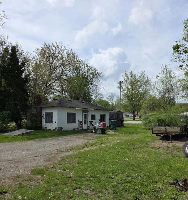 120 2nd St, Ionia, MI 48846 - back of property with a chimney and a yard