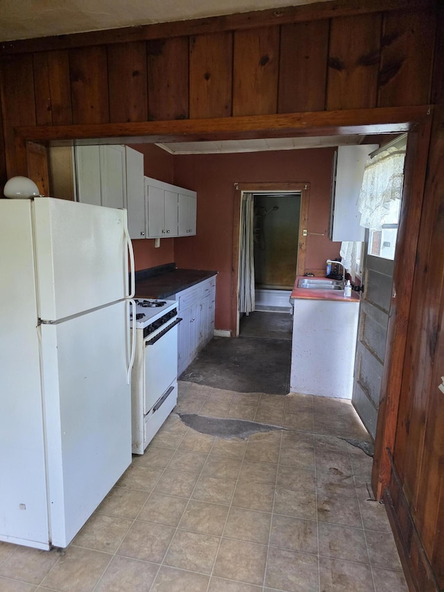 120 2nd St, Ionia, MI 48846 - kitchen with white appliances, a sink, and white cabinetry