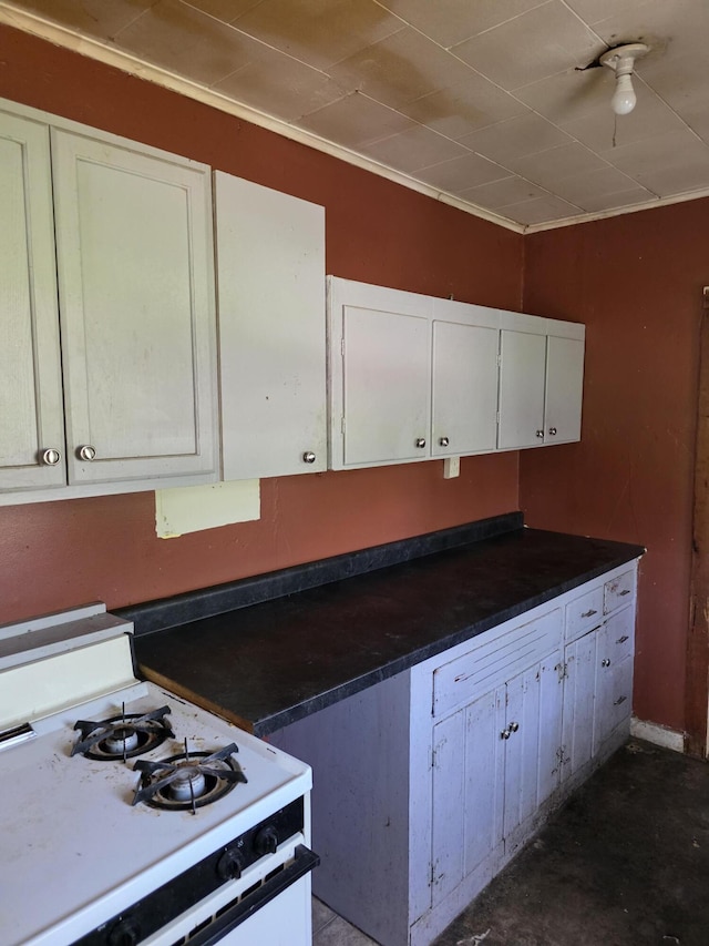 120 2nd St, Ionia, MI 48846 - kitchen with gas range gas stove, white cabinets, and dark countertops